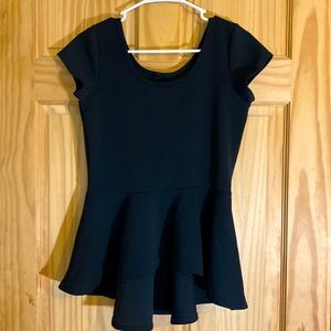 A medium black top made from silky like cotton and it’s longer in the back.